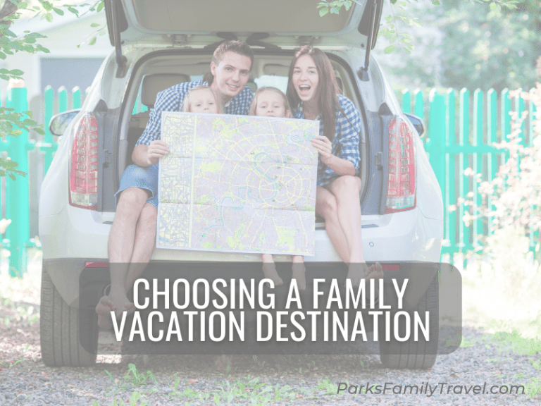 Family holding a map in the open trunk for a car