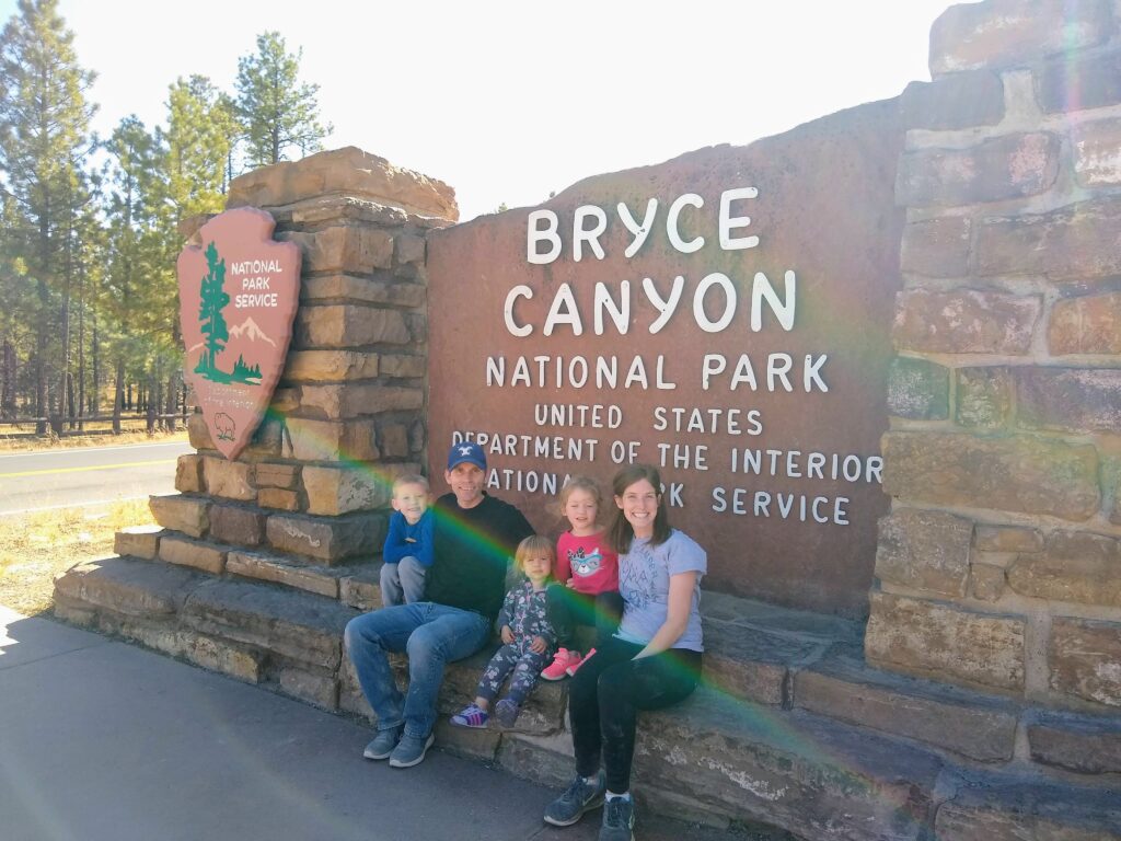 My family in front of the Bryce Canyon National Park entry sign
