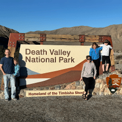 Fmaily in front of Death Valley entrance sign