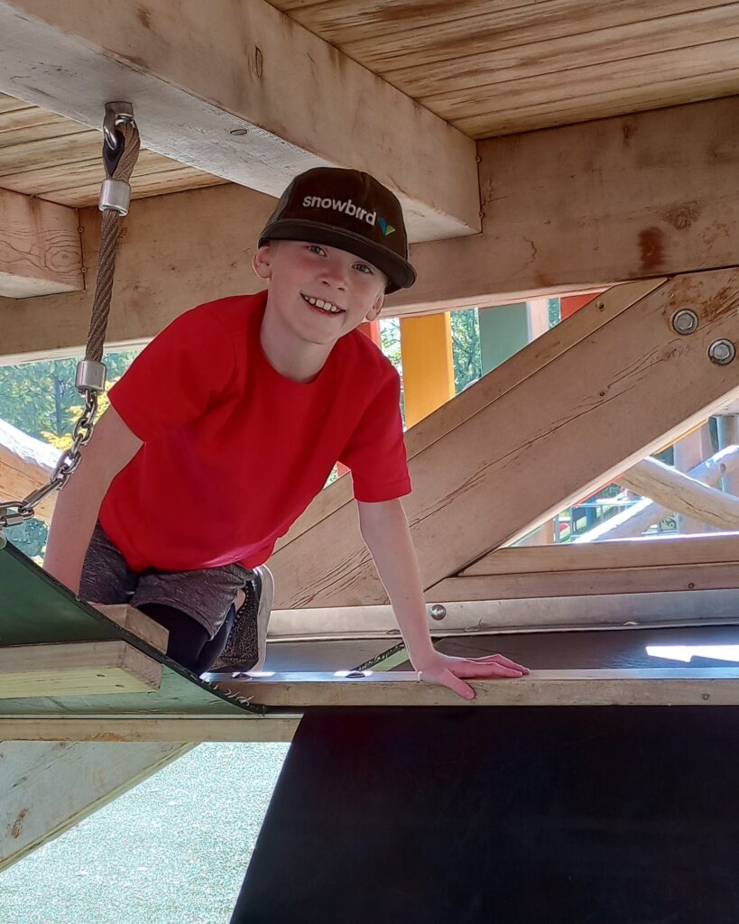 My son playing inside the tower play structure at Fort Kid playground in Knoxville, TN