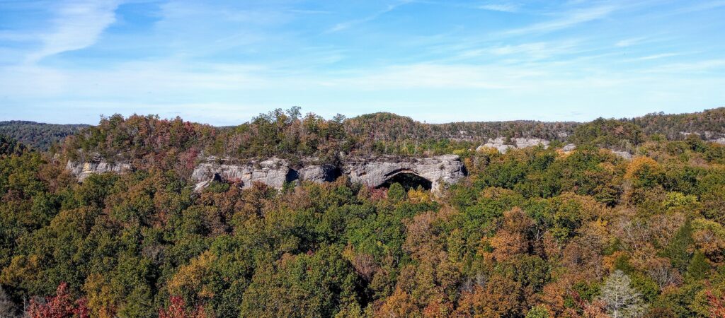 Natural Arch in the Daniel Booth National Forest Kentucky in October with fall leaves changing