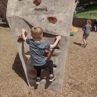 My son climbing a bouldering wall at Phil Baux Park