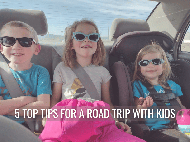 My kids on a road trip smiling with sunglasses on