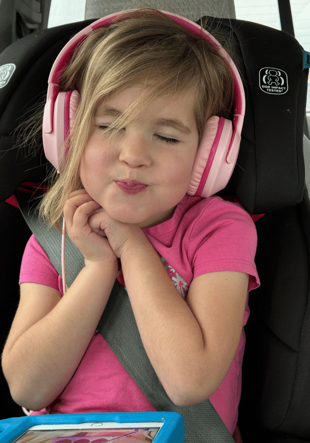 My daughter using her kids headphones while on a road trip.