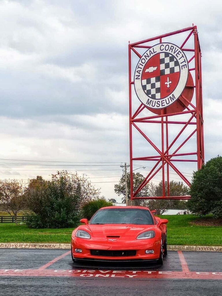 Red Corvette parked in front of the National Corvette Museum