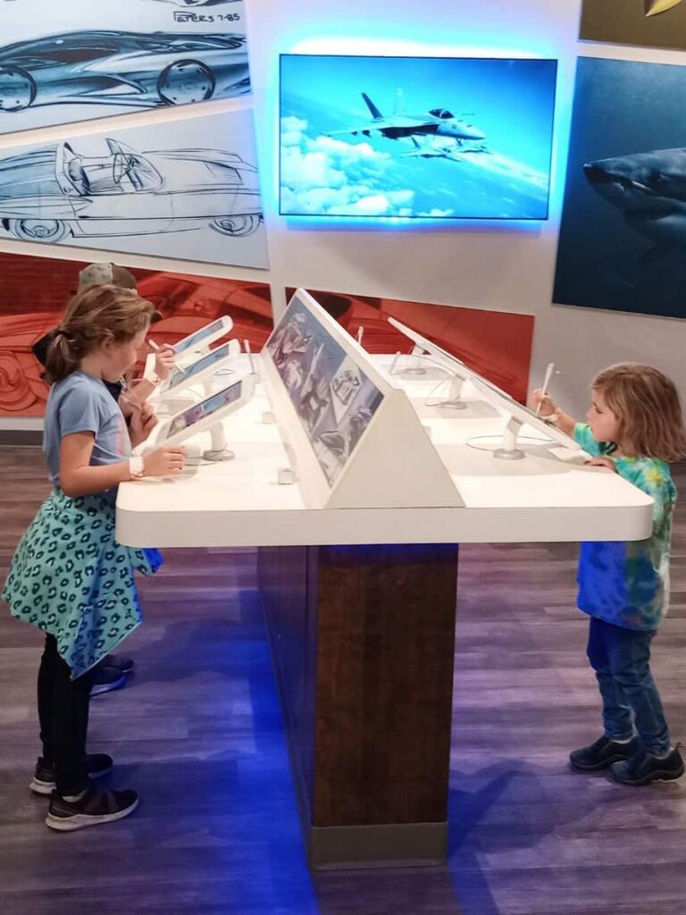 My three kids drawing their own car on tablets at the National Corvette Museum