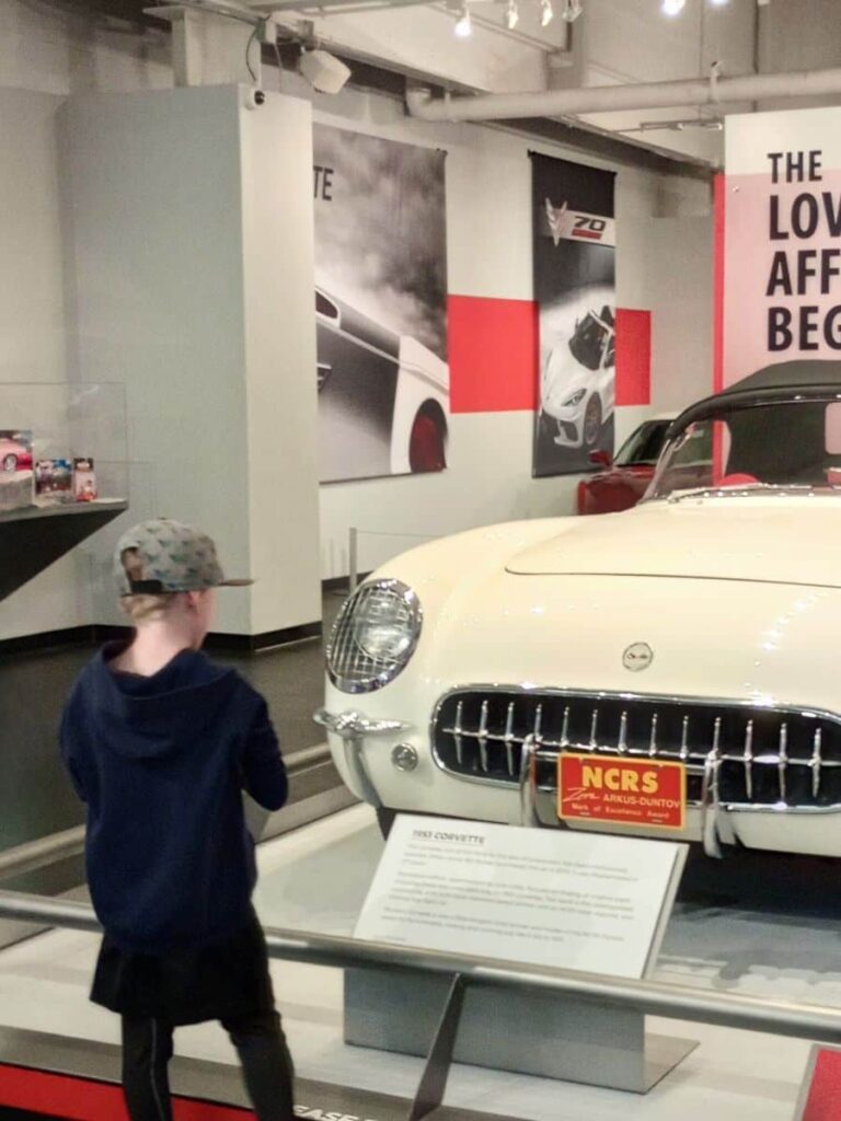 My son looking at a 1962 off white Corvette at the National Corvette Museum