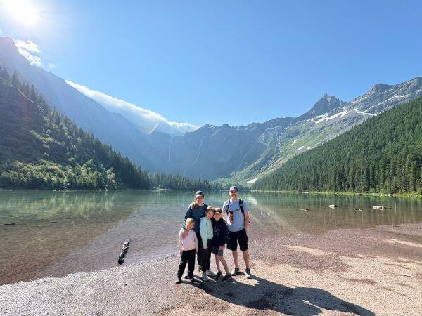 My family on a hike with a lake behind us in Glacier National Park