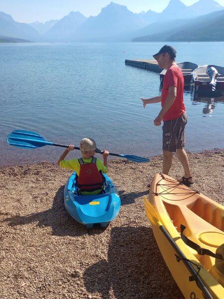 My husband instructing our son before he launches the kayak into Lake McDonald