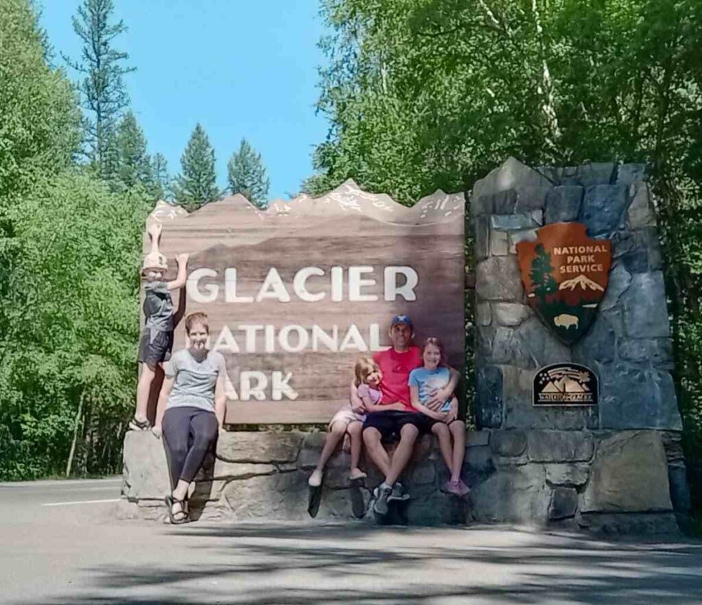 My family in front of the Glacier National Park entrance sign