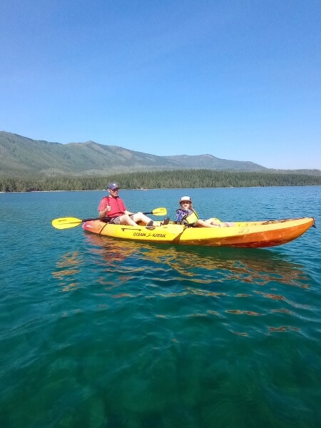 My husband and daughter in a tandem kayak on Lake McDonald in Glacier National Park