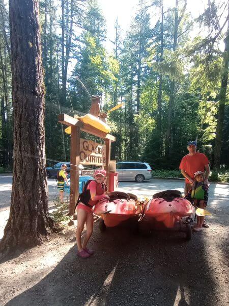 My family posing with our Kayaks in from of Glacier Outfitters in Apgar Village near Lake McDonald